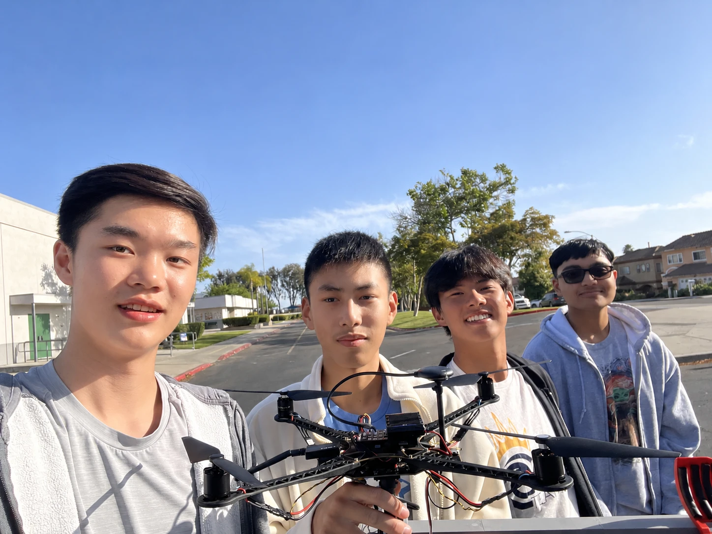 Team holding the drone with the revised arm and claw mechanism