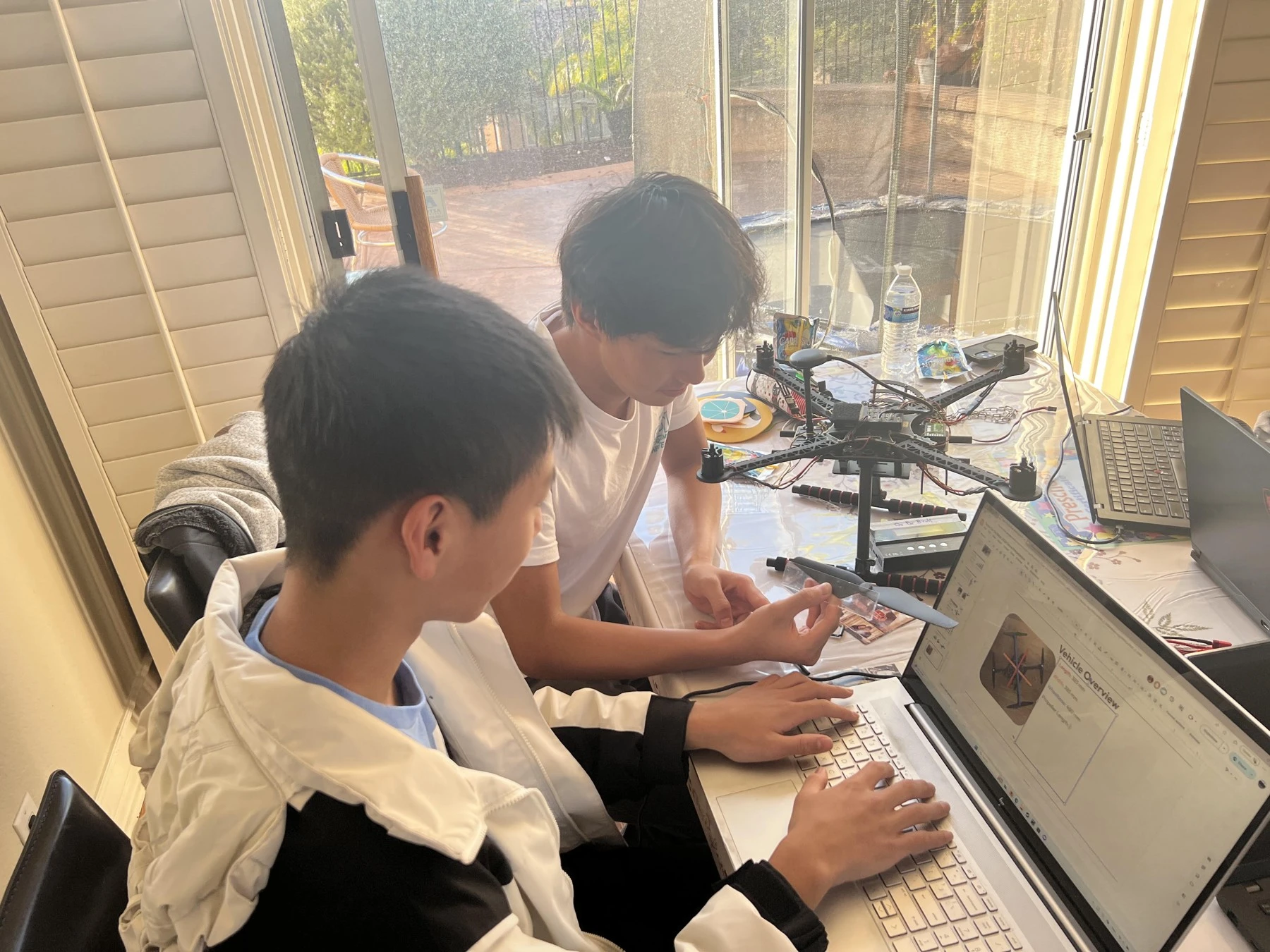 Teammates configuring the drone and software