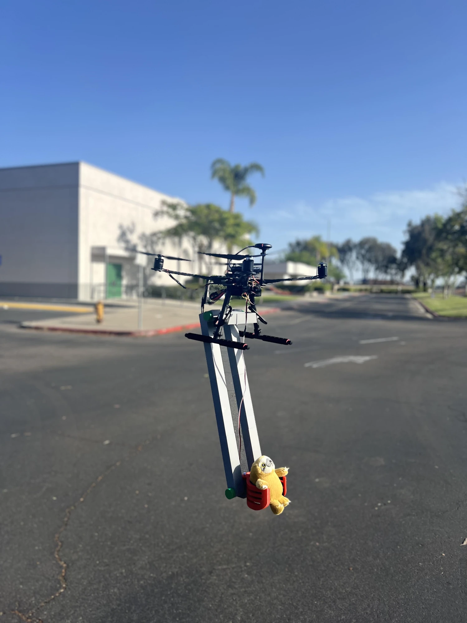 Drone with its claw mechanism holding a toy